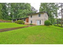 Charming two-story home with a well-manicured lawn and a convenient carport at 1675 Bouldercliff Se Ct, Atlanta, GA 30316