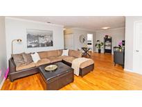 Inviting living room with a comfortable sectional sofa, ottoman, and hardwood floors at 1150 Collier Nw Rd # B5, Atlanta, GA 30318