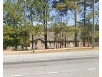 Brick building with multiple windows partially obscured by trees at 3428 Mount Zion Rd, Stockbridge, GA 30281
