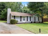 Charming single-story home featuring a well-maintained lawn, cozy front porch and a classic exterior at 183 Peachtree Ct, Riverdale, GA 30274