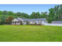 Charming single story home featuring a lovely lawn and a welcoming front porch at 5190 Due West Nw Rd, Powder Springs, GA 30127