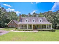 Charming home featuring a welcoming front porch, lush landscaping, and a well-manicured lawn at 3743 Johnston Rd, Winston, GA 30187
