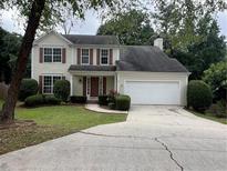 Charming two-story home with manicured lawn and attached two car garage at 11800 Carriage Park Ln, Johns Creek, GA 30097