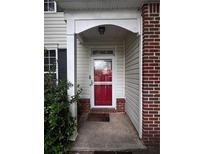 Inviting front entrance with a red door, brick accents, and traditional design elements at 4018 Carisbrook Dr, Union City, GA 30291