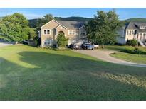 Charming two-story home with a well-maintained lawn and ample parking space on a sunny day at 30 Ne Moriah Way Ne Way, Rydal, GA 30171