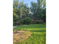 Cozy brick home with a spacious front yard garden perfect for outdoor activities at 2633 Yale Ter, Decatur, GA 30032
