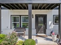 Charming front entrance with a decorative leaded glass front door and black trim at 505 Hampton Crossing, Woodstock, GA 30188