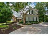 Charming home featuring stone accents, landscaped yard, mature trees, and long driveway at 700 Broadlands Ln, Powder Springs, GA 30127
