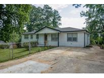 Charming brick home with a well-maintained yard, inviting curb appeal, and long driveway at 7144 Carolyn Cir, Lithia Springs, GA 30122