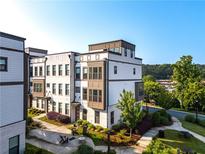 Beautiful modern townhome with manicured lawn, courtyard, and outdoor seating at 2076 Holtz Ln, Atlanta, GA 30318