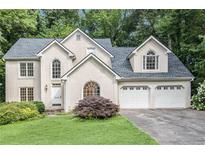 Charming two-story stucco home with a well-manicured lawn and an attached two-car garage at 3420 Cranborne, Marietta, GA 30062