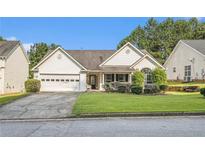 Charming single-story home with well-maintained lawn, a two-car garage, and welcoming curb appeal at 2397 Cove Lake Rd, Lithonia, GA 30058