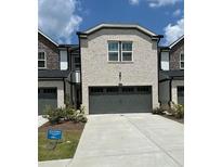 Two-story exterior elevation with a gray brick facade and a two-car garage at 2670 Greenbelt Rd, Snellville, GA 30078