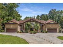 Stately brick home featuring symmetrical design, dual garages, and manicured landscaping at 450 Dorset Sw Way, Smyrna, GA 30082