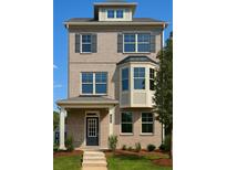 Charming two-story brick home featuring a covered entry and large windows at 535 Fundao Ln, Lawrenceville, GA 30046