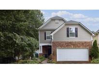 Charming two-story home features stone accents, a two-car garage, and a well-maintained front yard at 2468 Whistle Stop Dr, Norcross, GA 30071
