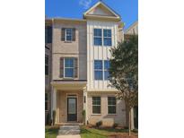 Charming two-story townhome featuring a brick facade, large windows, and a well-maintained lawn at 537 Fundao Ln, Lawrenceville, GA 30046