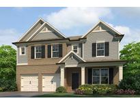 Charming two-story home with a brick and siding exterior, complemented by a well-manicured lawn and flowerbeds at 1797 Kingsmere Run Dr, Loganville, GA 30052