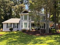 Charming two-story home with mature landscaping and a welcoming front porch at 1655 Oak Crest Ct, Marietta, GA 30066