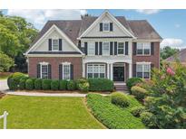 Charming two-story brick home featuring manicured landscaping and classic architectural details at 2444 Mossy Branch Dr, Snellville, GA 30078