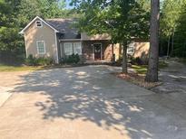 Charming single Gathering home with well maintained landscaping and an expansive driveway at 255 Emerald Pointe Dr, Carrollton, GA 30116