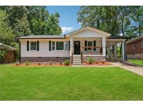Charming, renovated home with a well-manicured lawn and a covered carport at 1978 Ethel Ln, Decatur, GA 30032