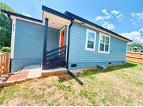Charming light-blue home boasting an orange front door and neatly maintained lawn at 2526 Center Nw St, Atlanta, GA 30318