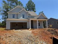 Charming two-story home with an unfinished landscape and visible garage at 340 Bloomfield Cir, Canton, GA 30114