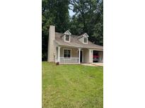 Charming home featuring a well-maintained lawn, classic architectural design, and an inviting entrance at 1009 Autumn Crest Ct, Stone Mountain, GA 30083