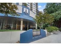 Upscale condo building entrance with manicured landscaping and prominent signage at 1130 Piedmont Ne Ave # 404, Atlanta, GA 30309