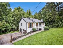 Charming renovated home featuring a white exterior, stylish shutters, and a lovely front porch at 129 Fawn Trail Trl, Hiram, GA 30141