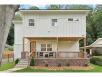 Charming two-story home with a welcoming front porch and beautifully landscaped yard at 1266 Elizabeth Sw Ave, Atlanta, GA 30310
