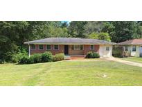 Charming single-story brick home featuring a well-maintained front yard and inviting entrance at 3377 Brookfield Ln, Decatur, GA 30032