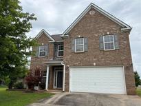 Charming two-story brick home featuring a two-car garage and well-maintained landscaping at 3457 Dacite Ct, South Fulton, GA 30349