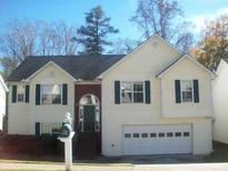 Charming two-story home featuring a front-facing garage and well-maintained yard at 355 Tambec Nw Trce, Lilburn, GA 30047