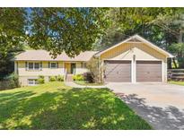 Charming single-Gathering home featuring a well-manicured lawn and attached two-car garage at 2220 Williams Ln, Cumming, GA 30028