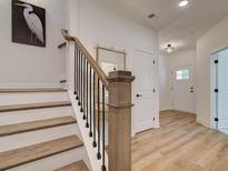 Bright entry staircase with hardwood steps, black metal railing, and elegant decor at 1983 Deco Dr, Kennesaw, GA 30144