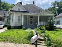 Charming, two-story home with a inviting front porch and well-kept lawn with nice landscaping at 3155 E East Point E St, East Point, GA 30344