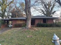 Charming single story brick home featuring mature trees and a covered carport at 1713 Cahoon Sw St, Atlanta, GA 30310