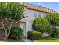 Charming townhouse featuring a well-manicured lawn and mature trees for added curb appeal at 502 Bridge Se Ln, Smyrna, GA 30082