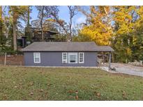 Charming single-story home featuring a covered front porch and well-manicured front lawn, ideal for suburban living at 5861 Community Rd, Mableton, GA 30126
