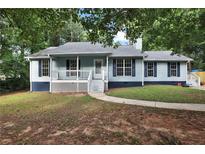 Charming single-story home featuring a cozy front porch and traditional blue siding at 6211 Ward Rd, Union City, GA 30291
