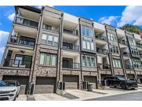 Modern townhome exterior featuring brick accents, private balconies, and convenient garage parking at 383 Pratt Se Dr # 503, Atlanta, GA 30315