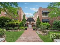 Charming brick apartment building with inviting landscaping and a walkway leading to the entrance at 1026 Saint Charles Ne Ave # 8, Atlanta, GA 30306