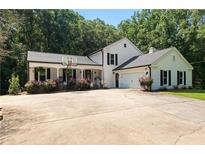 Charming two-story home with a basketball hoop, attached garage and meticulously maintained landscaping at 12550 Hutcheson Ferry Rd, Palmetto, GA 30268