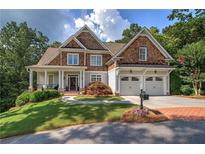 Beautiful two-story home with a brick driveway, two-car garage, and a nicely landscaped front yard at 16 Cambridge Way, Cartersville, GA 30121