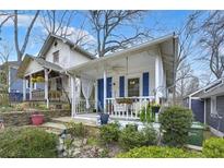 Charming cottage-style home featuring a cozy front porch with blue accents and well-maintained landscaping at 818 Virgil Ne St, Atlanta, GA 30307