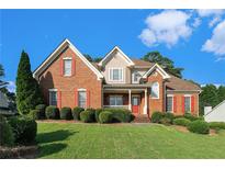 Charming two-story brick home featuring well-maintained landscaping and a welcoming front porch at 1290 Mount Mckinley Dr, Grayson, GA 30017