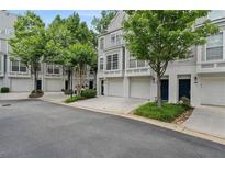 Charming townhome exteriors featuring attached garages and manicured landscaping at 1154 Village Se Ct, Atlanta, GA 30316