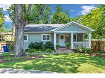 Charming single-story home featuring a welcoming front porch and well-manicured lawn and landscape at 111 Marona Street Ne Ne St, Atlanta, GA 30307